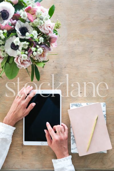 Vertical stock photo of feminine desktop with tablet