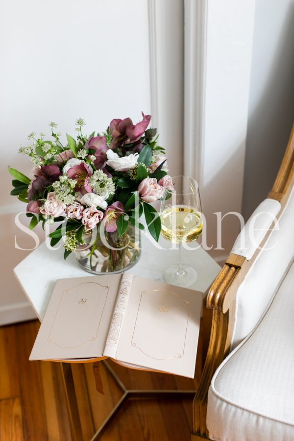 Vertical stock photo of flowers and wine glass