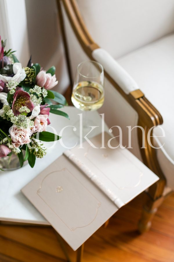 Vertical stock photo of wine glass and book