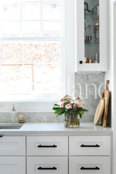 Vertical stock photo of flowers on kitchen counter