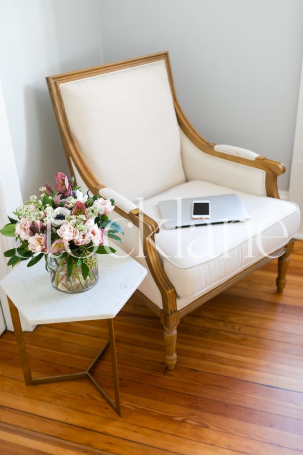 Vertical stock photo of laptop in chair