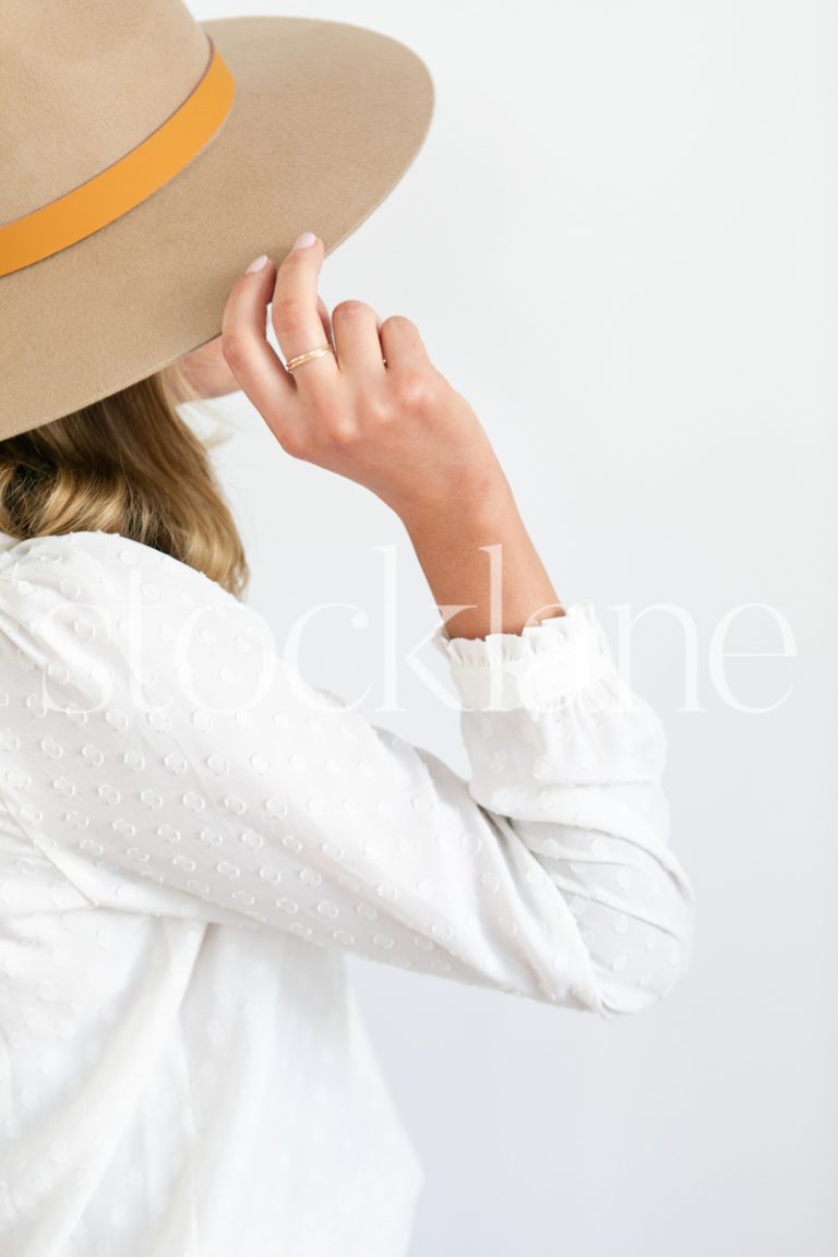 Vertical stock photo of woman wearing a hat