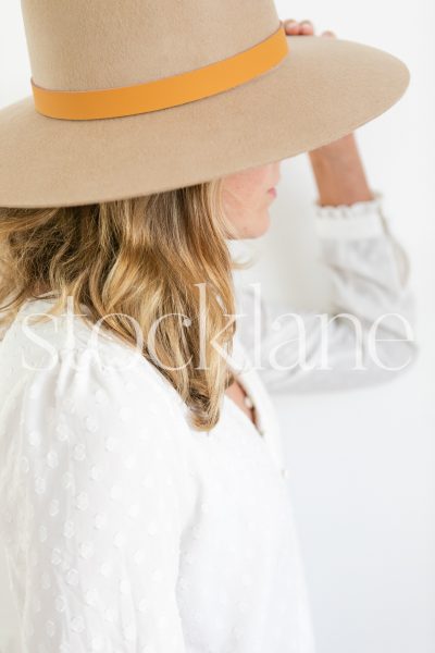 Vertical stock photo of woman wearing a hat