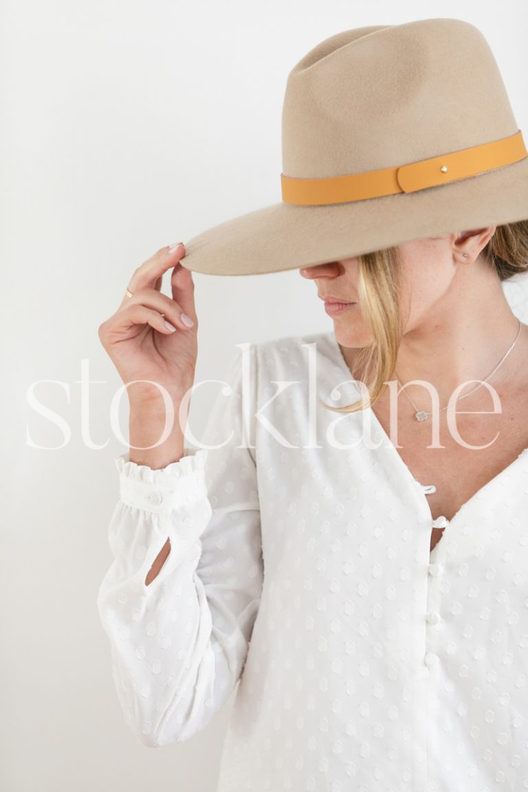 Vertical stock photo of woman wearing a hat