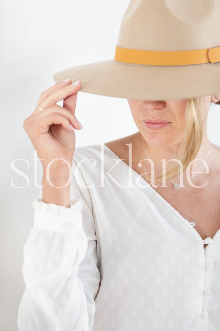 Vertical stock photo of woman wearing a hat