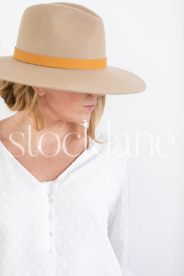 Vertical stock photo of woman wearing a hat