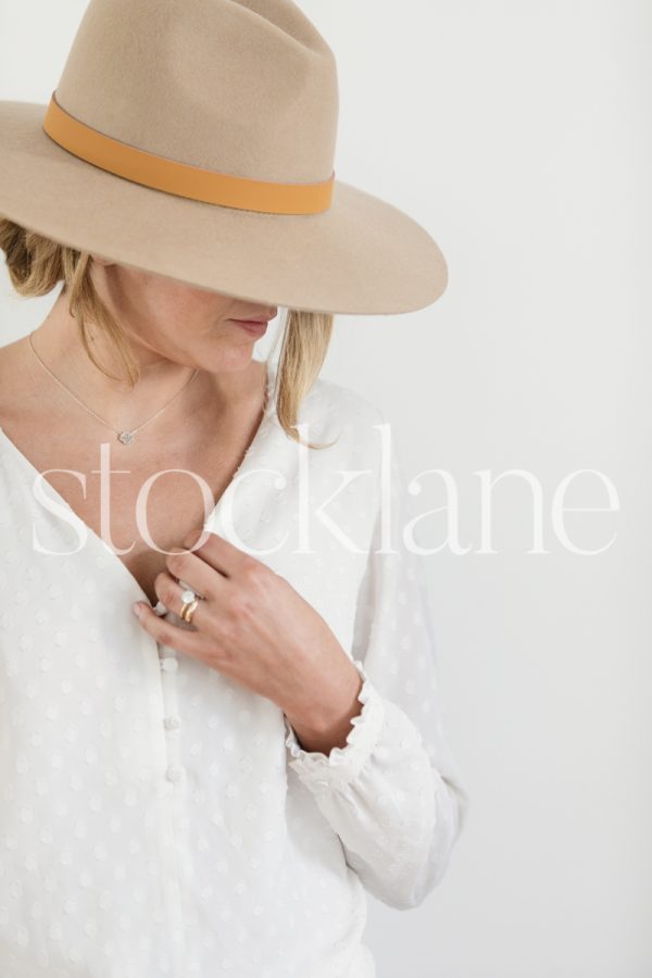 Vertical stock photo of woman wearing a hat