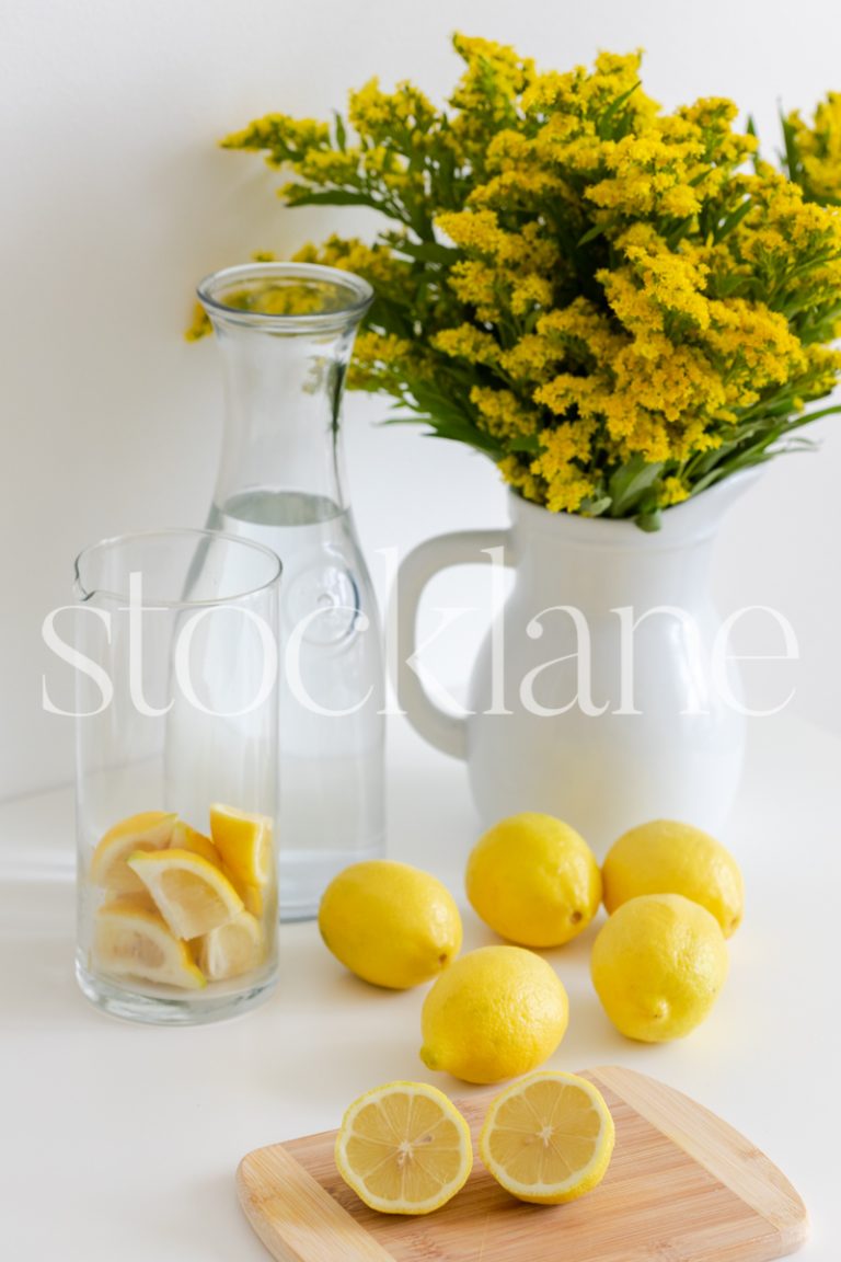 Vertical lifestyle stock photo of lemons and lemonade.