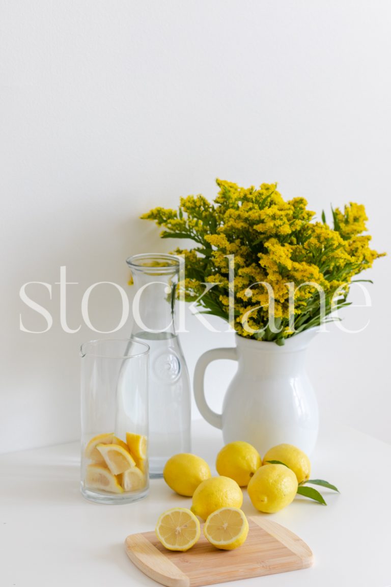 Vertical lifestyle stock photo of lemons and lemonade.