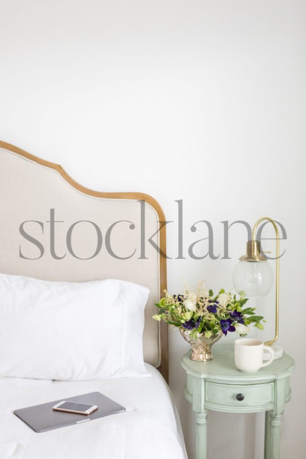 Vertical stock photo of neutral colored bedroom