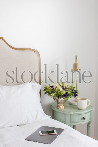 Vertical stock photo of neutral colored bedroom