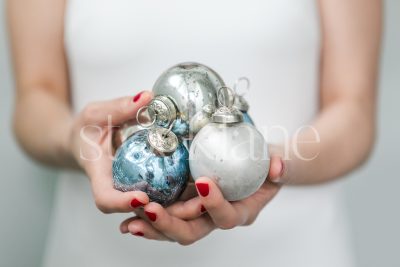 Horizontal Stock photo of a woman in a white dress with Christmas ornaments