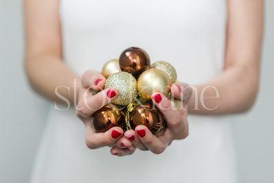 Horizontal Stock photo of a woman in a white dress with Christmas ornaments