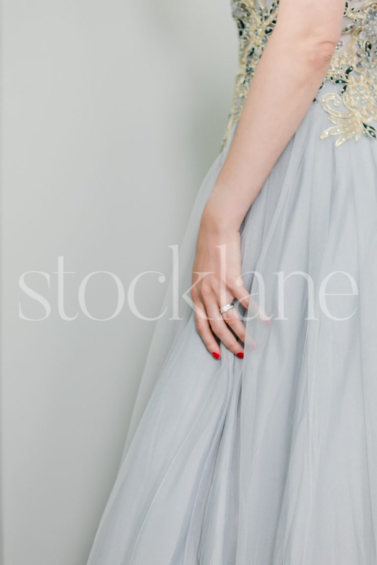 Vertical stock photo of a woman in a light blue dress