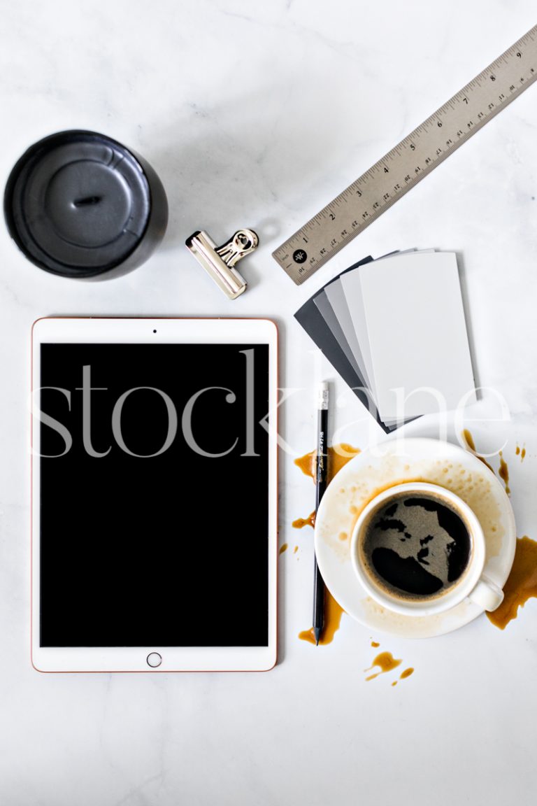 Vertical stock photo of desktop with iPad and coffee