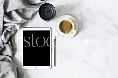 Horizontal stock photo of a desktop with an iPad and a cup of coffee