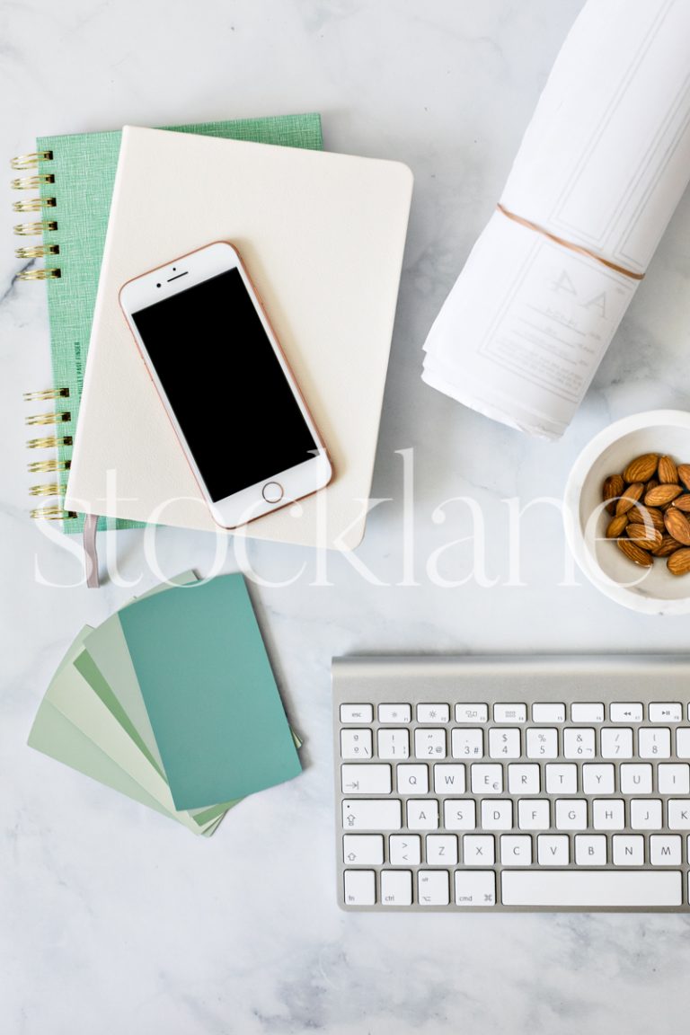 Vertical stock photo of a desktop with an iPhone