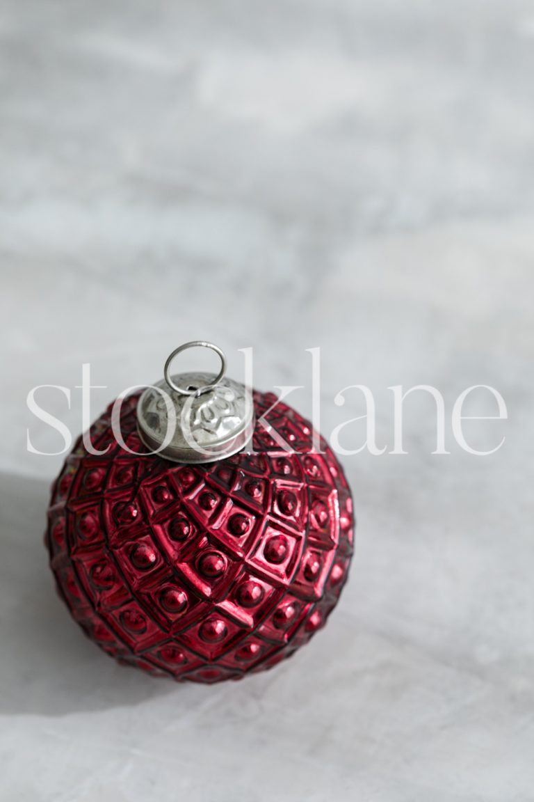 Vertical stock photo of red Christmas ornament.