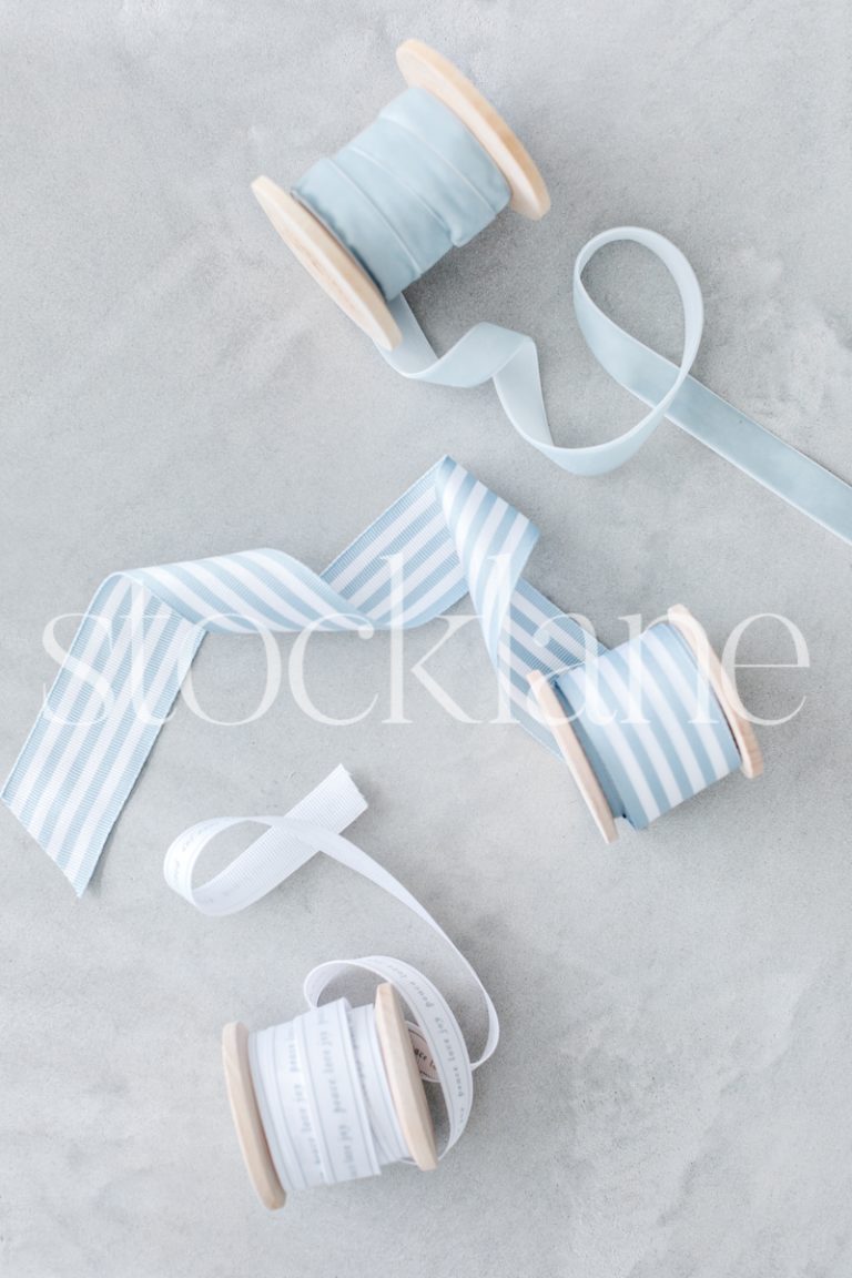 Vertical stock photo of Christmas light blue ribbons