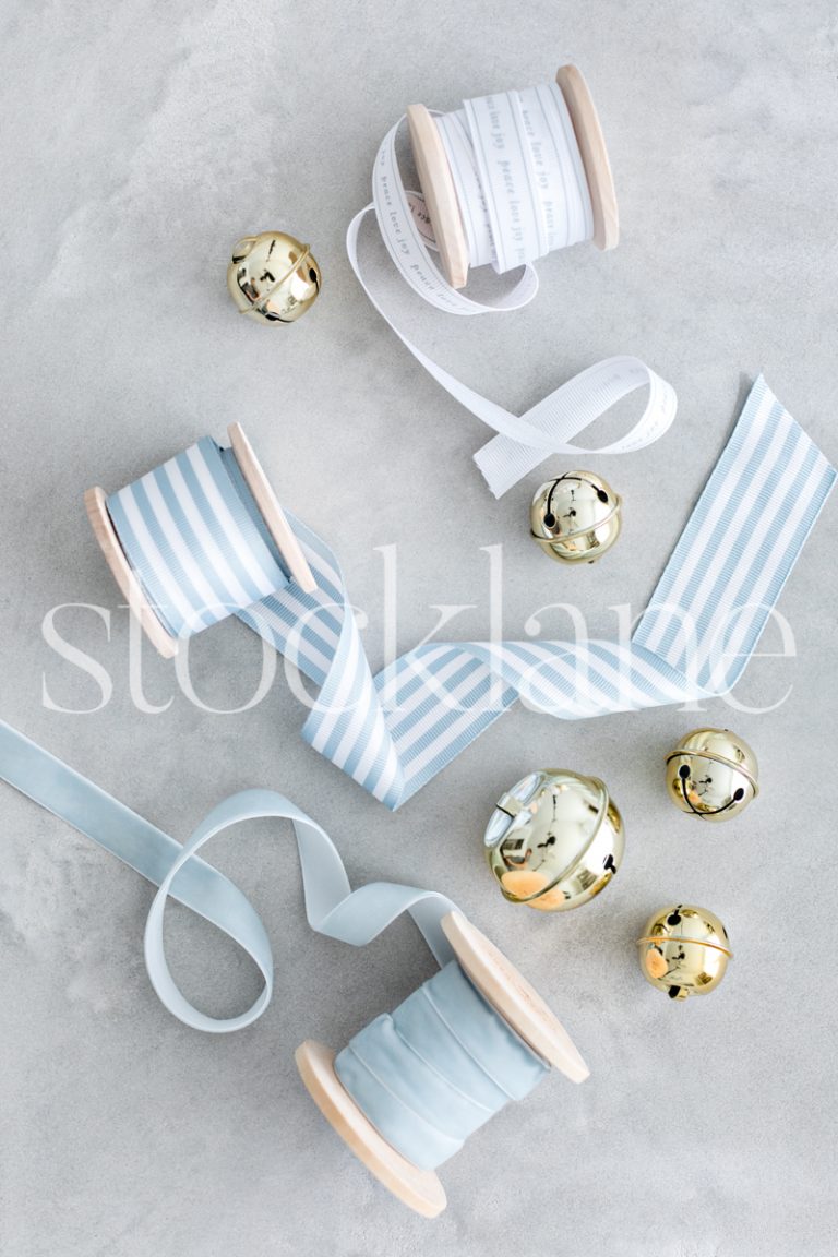 Vertical stock photo of Christmas light blue ribbons and bells.