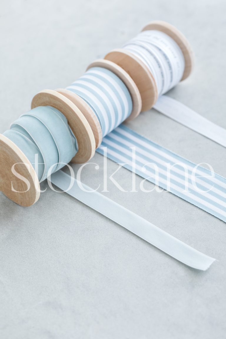 Vertical stock photo of Christmas light blue ribbons.