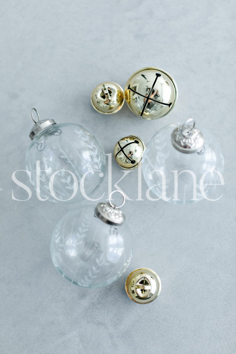 Vertical stock photo of Christmas glass ornaments and bells.