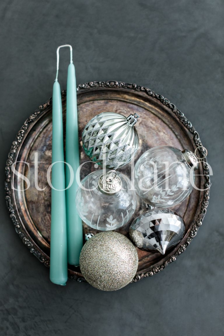 Vertical stock photo of Christmas ornaments and candles.