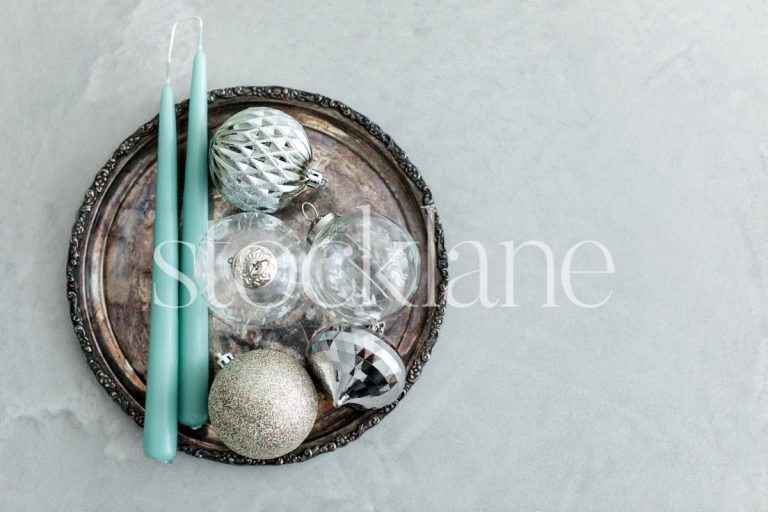 Horizontal stock photo of Christmas ornaments and candles.