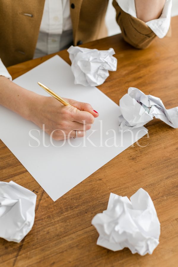 Vertical stock photo of a woman writing.