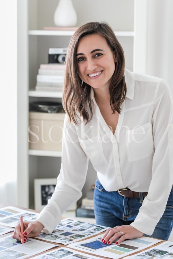 Vertical stock photo of a woman working on a mood board