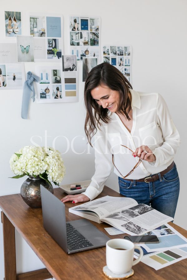 Vertical stock photo of a woman working on her laptop.