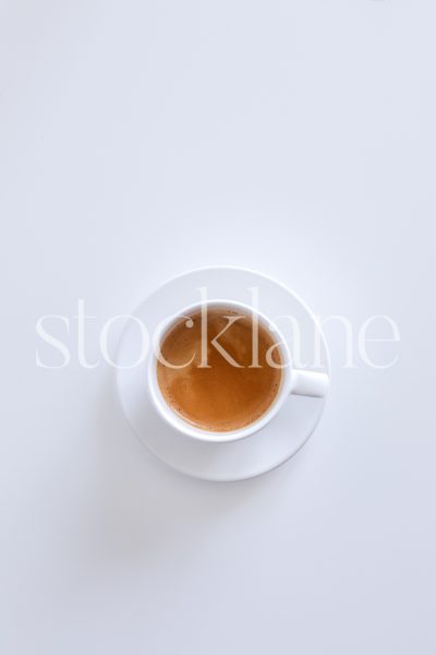 Vertical stock photo of a coffee cup on a white background