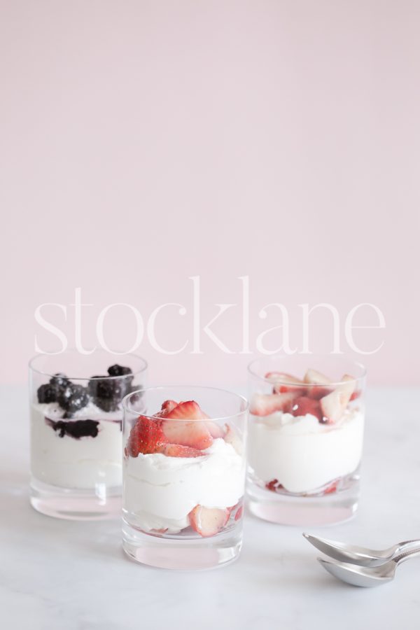 Vertical stock photo of berries and cream desert