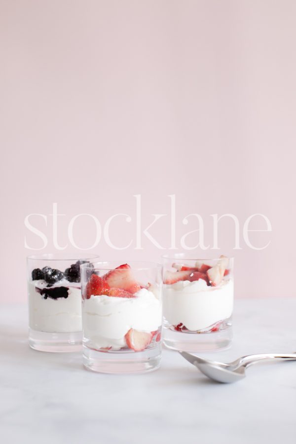 Vertical stock photo of berries and cream desert