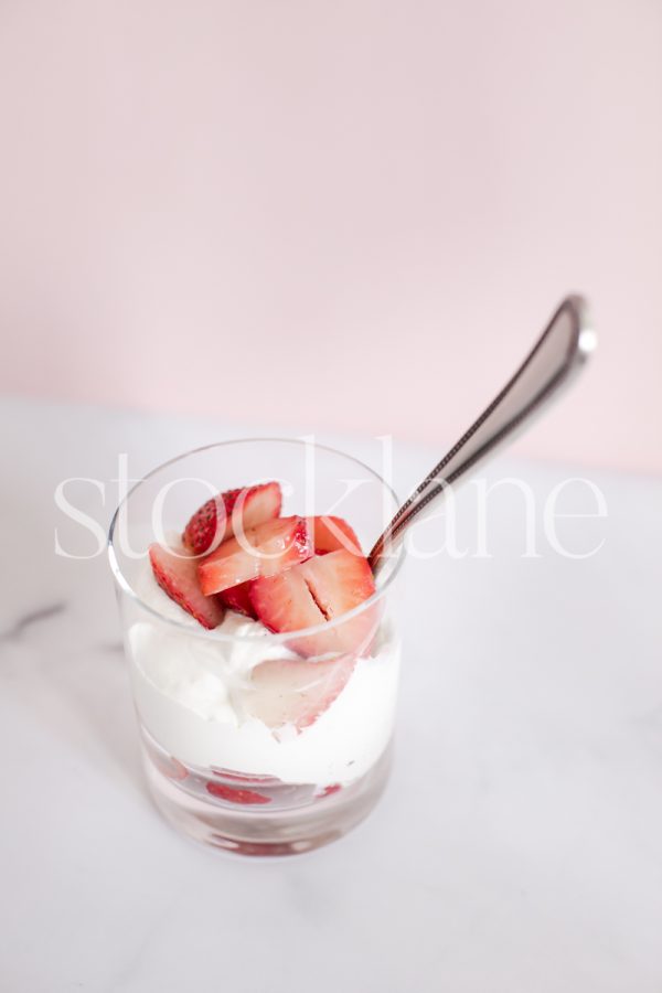 Vertical stock photo of strawberries and cream