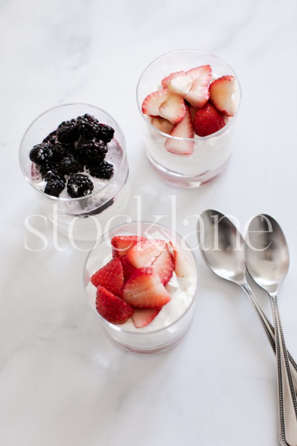 Vertical stock photo of berries and cream desserts