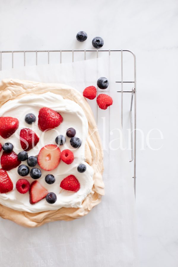 Vertical stock photo of a pavlova with berries