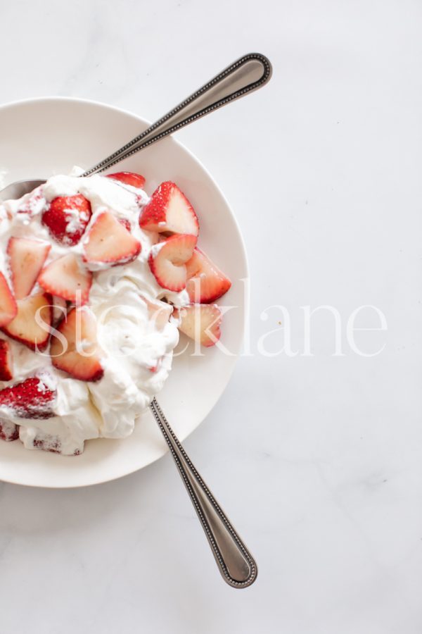 Vertical stock photo of strawberries and cream