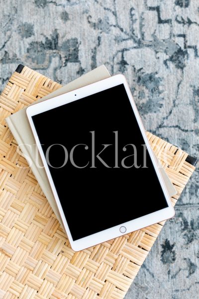 Vertical stock photo of an iPad on a woven bench