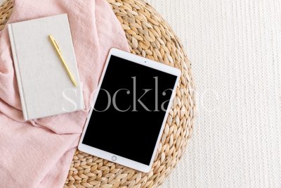 Horizontal stock photo of a tablet mockup in neutral and pink colors.