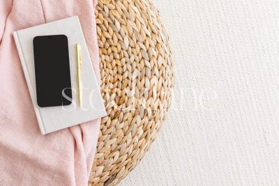 Horizontal stock photo of a phone mockup in neutral and pink colors.