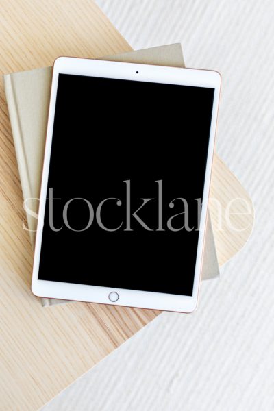 Vertical stock photo of a tablet mockup in neutral colors.