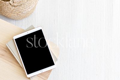 Horizontal stock photo of a tablet mockup in neutral colors.