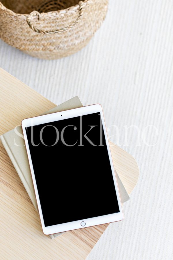 Vertical stock photo of a tablet mockup in neutral colors.