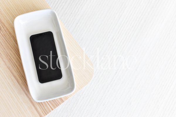 Horizontal stock photo of a phone mockup in neutral colors.