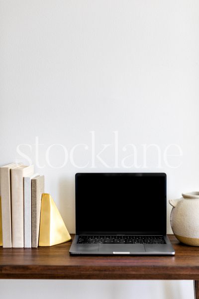 Vertical stock photo of a computer mockup in neutral colors.