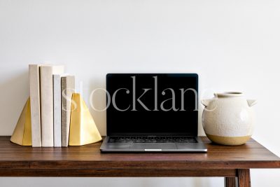 Horizontal stock photo of a computer mockup in neutral colors.