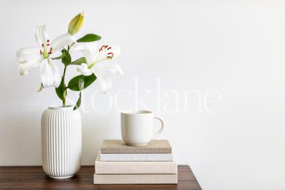 Horizontal Stock photo of Asian Lilies with books and a cup of coffee