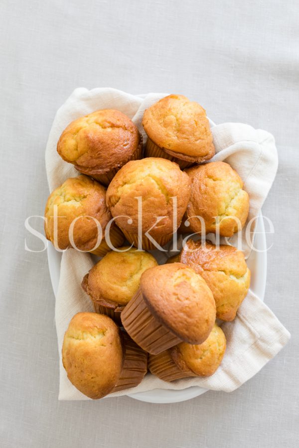 Vertical stock photo of a plate full of muffins.