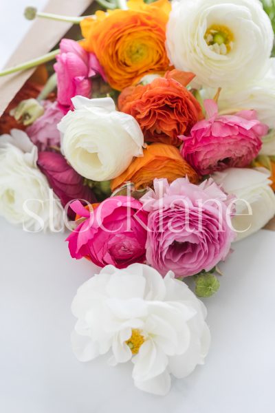 Vertical stock photo of a bouquet of ranunculus.